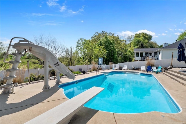 view of pool with a fenced in pool, a water slide, and a fenced backyard
