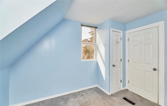 bonus room with baseboards, visible vents, carpet flooring, and vaulted ceiling