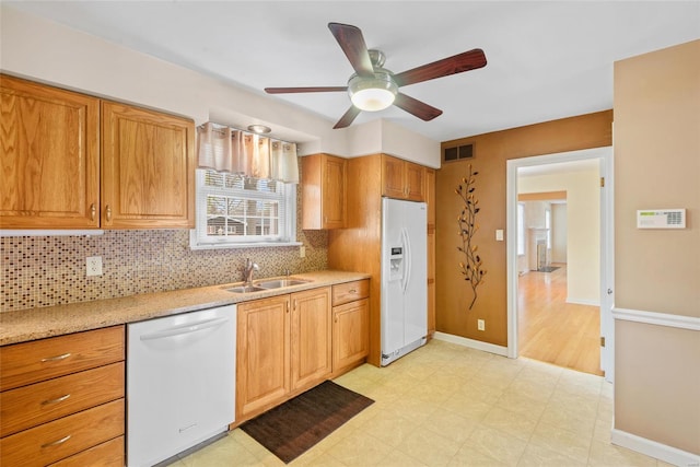 kitchen with ceiling fan, white appliances, tasteful backsplash, visible vents, and a sink