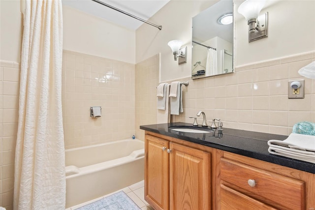 bathroom featuring tile walls, shower / tub combo with curtain, tile patterned flooring, and vanity
