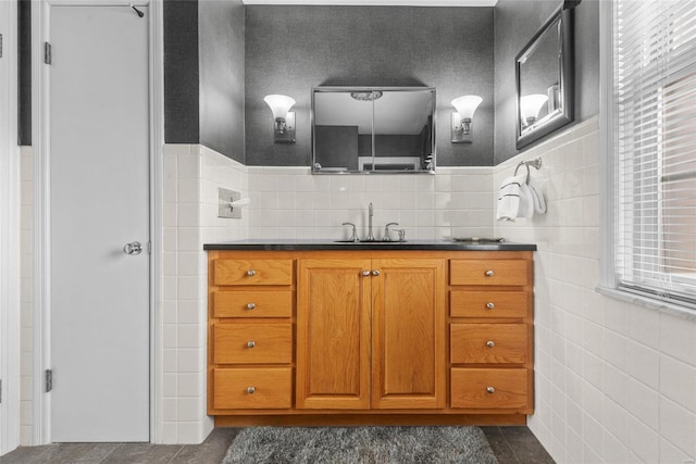 bathroom featuring tile patterned floors, tile walls, and vanity