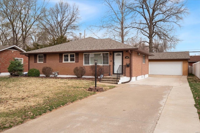 ranch-style house featuring an outbuilding, fence, a shingled roof, a front lawn, and brick siding