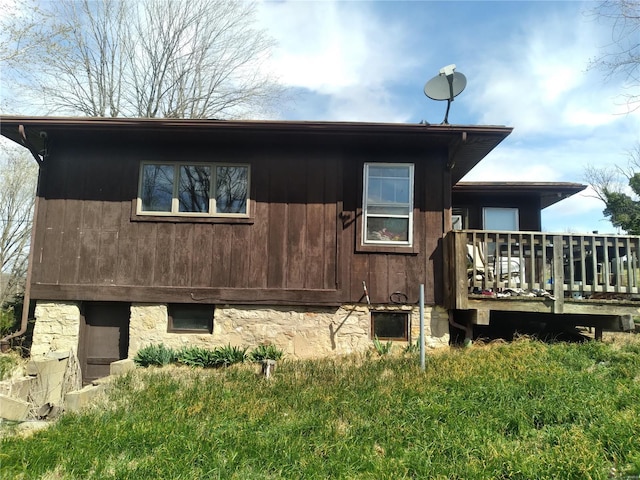 view of property exterior with a wooden deck