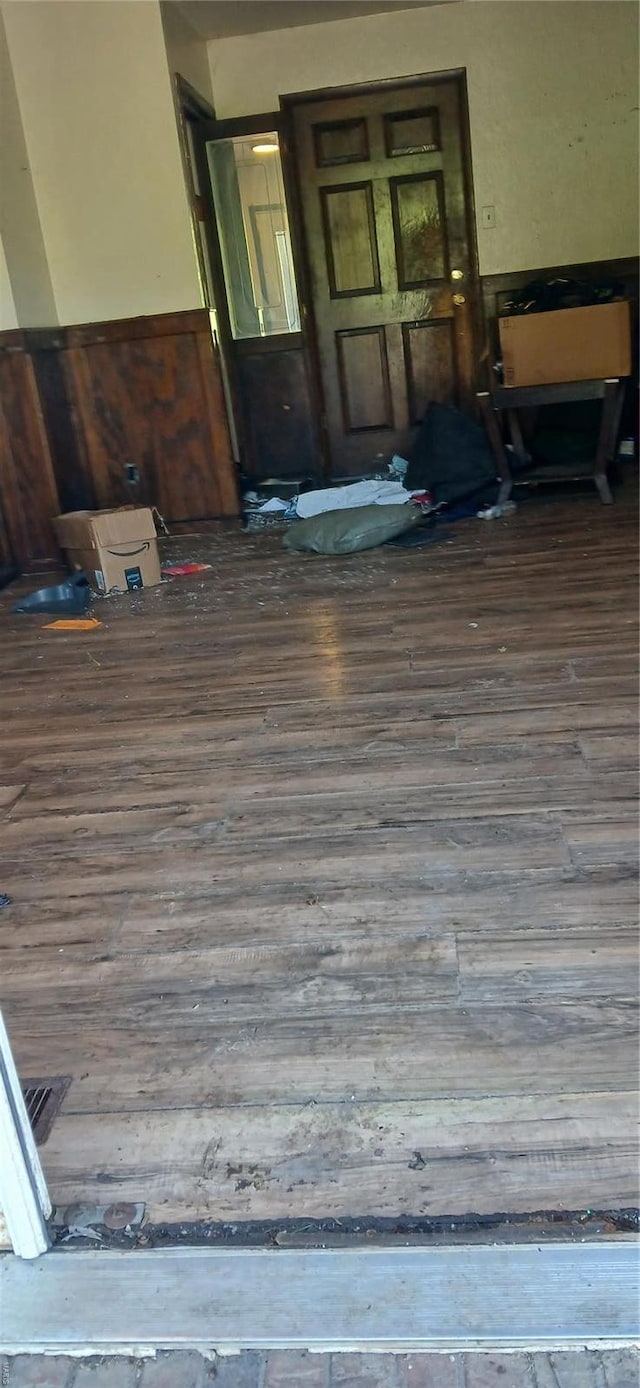 unfurnished room featuring wainscoting and wood finished floors