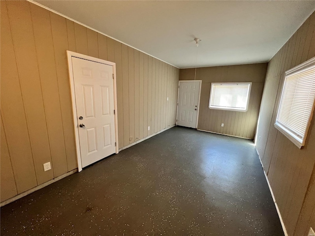 spare room with a healthy amount of sunlight and finished concrete floors