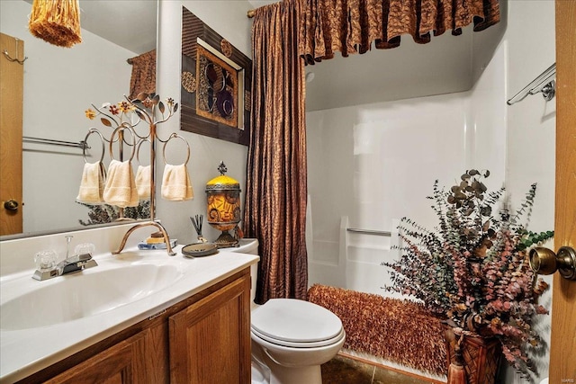 full bathroom with toilet and vanity