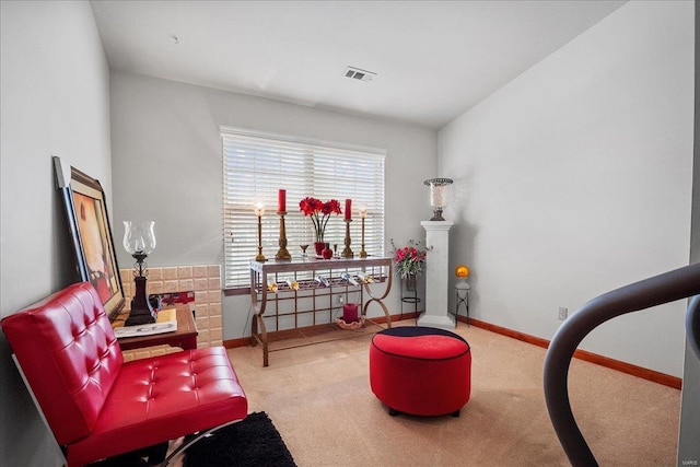 living area with visible vents, baseboards, and carpet flooring