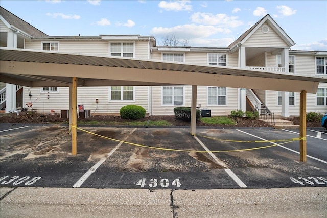 covered parking lot featuring stairs