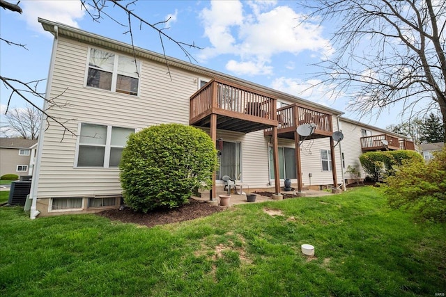 rear view of property with cooling unit and a lawn
