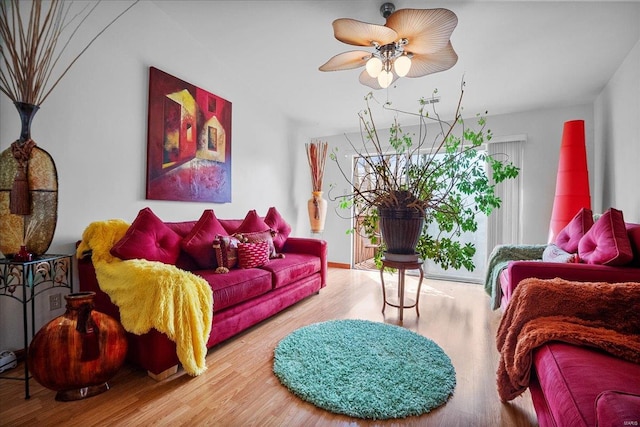living room with a ceiling fan and wood finished floors