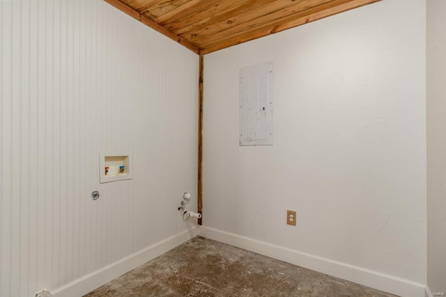 clothes washing area featuring baseboards, electric panel, hookup for a gas dryer, laundry area, and hookup for a washing machine