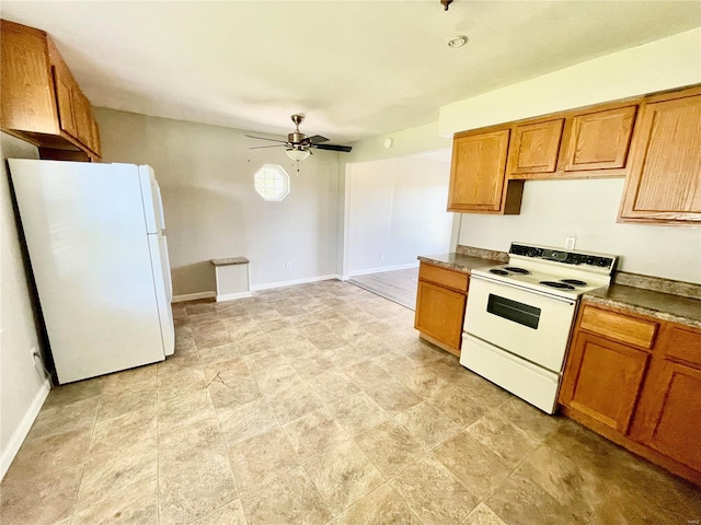 kitchen featuring dark countertops, a ceiling fan, brown cabinetry, white appliances, and baseboards