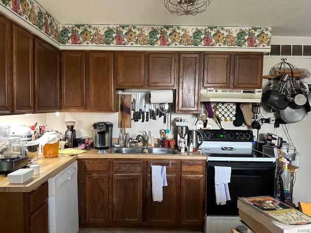 kitchen featuring range with electric cooktop, under cabinet range hood, dishwasher, light countertops, and a sink