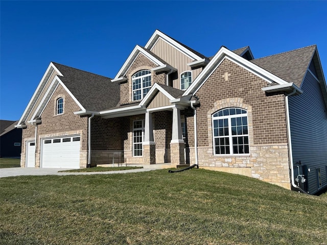 craftsman-style house with board and batten siding, a garage, a front lawn, concrete driveway, and stone siding