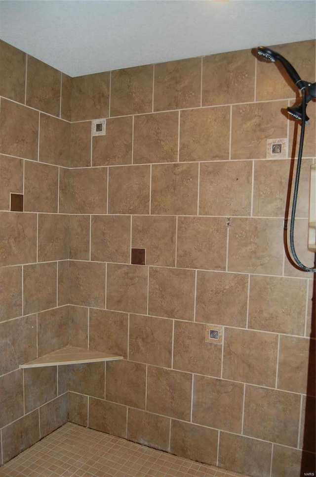 bathroom with tiled shower