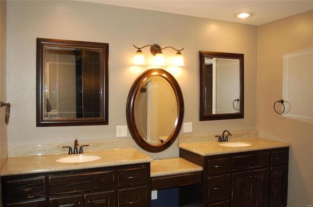 bathroom featuring two vanities and a sink