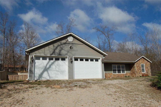 ranch-style home with stone siding and dirt driveway