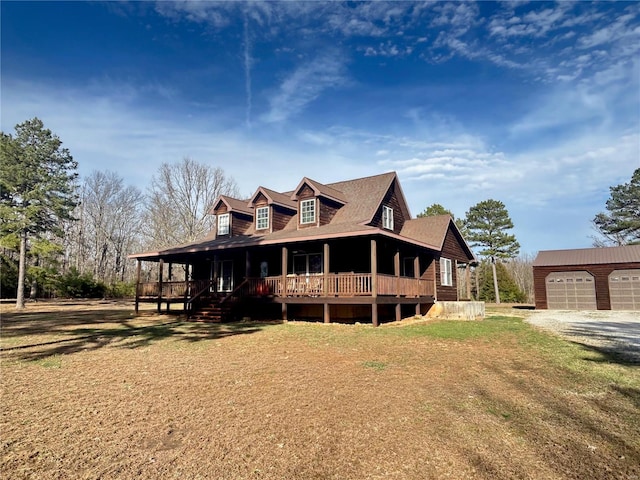 view of front of house featuring a garage, a porch, and an outdoor structure