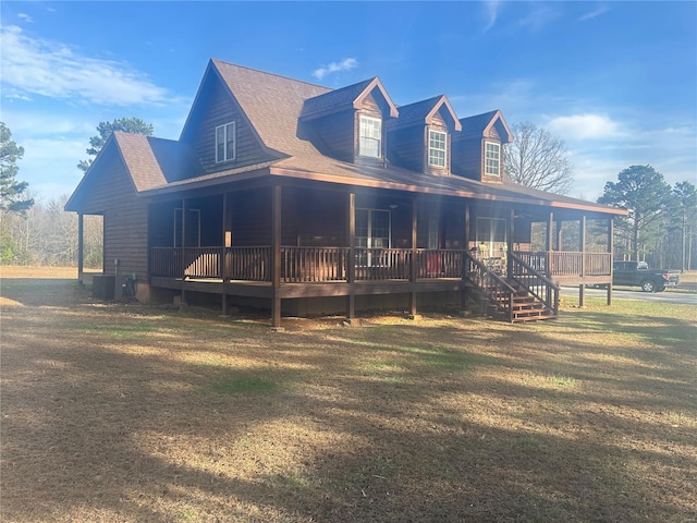 view of front of home featuring central AC unit, a shingled roof, and a front yard