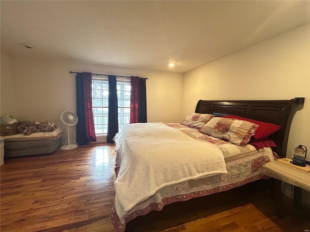 bedroom with dark wood-style flooring