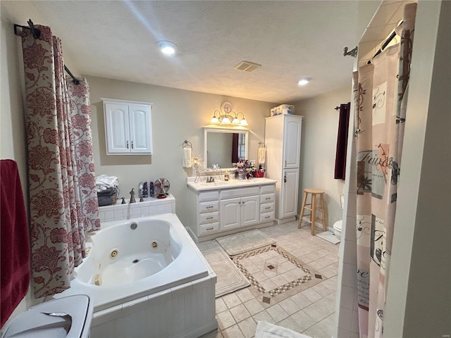 full bathroom featuring visible vents, toilet, a whirlpool tub, tile patterned floors, and vanity