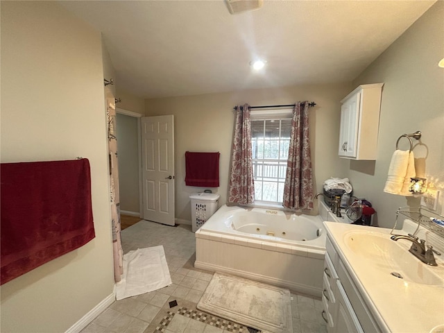 full bath with visible vents, baseboards, vanity, and a whirlpool tub