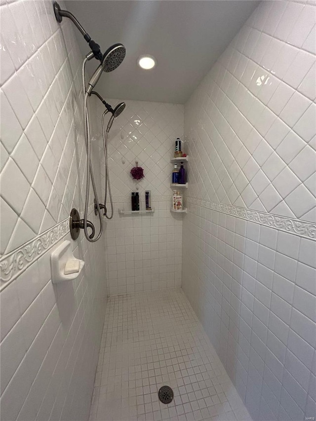 bathroom with a tile shower, recessed lighting, and tile patterned floors