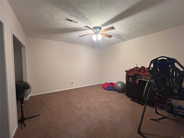 playroom with visible vents, baseboards, carpet flooring, a textured ceiling, and a ceiling fan
