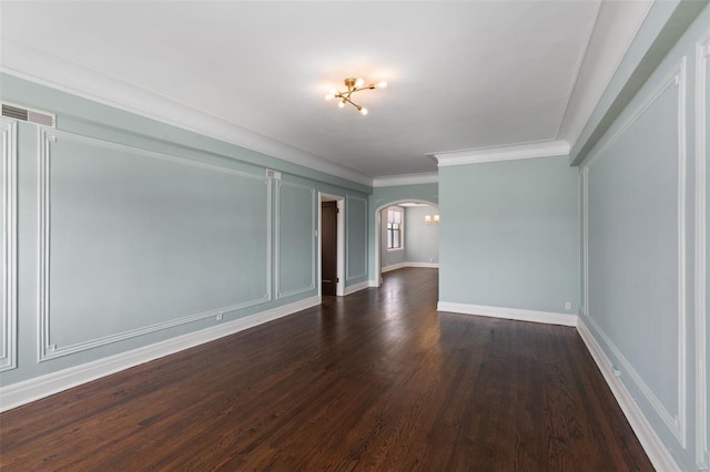 spare room with baseboards, visible vents, arched walkways, ornamental molding, and dark wood-style flooring
