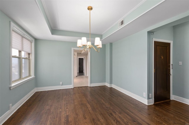 empty room with visible vents, baseboards, a raised ceiling, dark wood finished floors, and an inviting chandelier