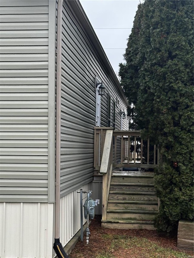 view of side of home with a wooden deck and stairway