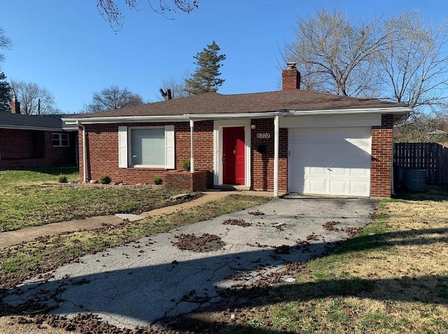 ranch-style home featuring a front lawn, an attached garage, brick siding, and a chimney