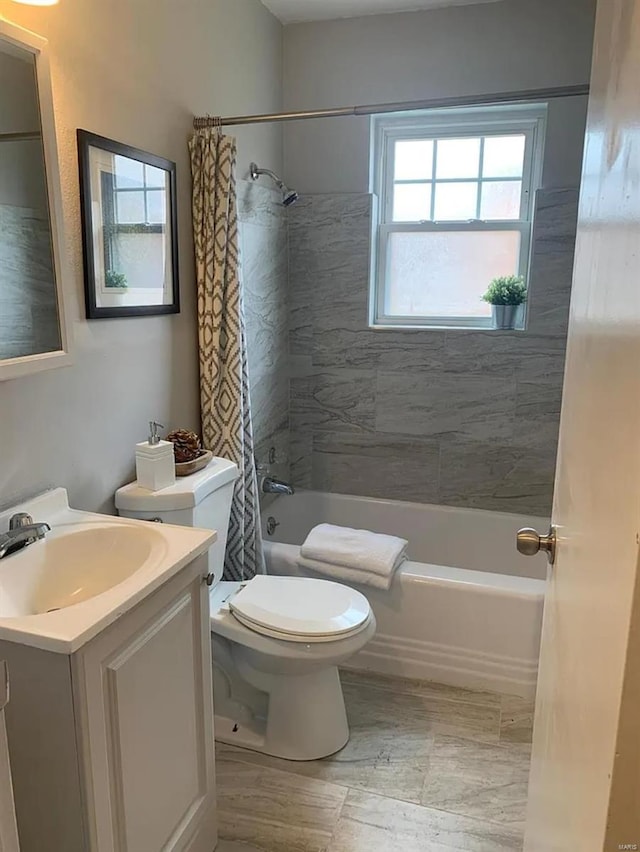 full bathroom featuring vanity, toilet, and shower / bathtub combination with curtain