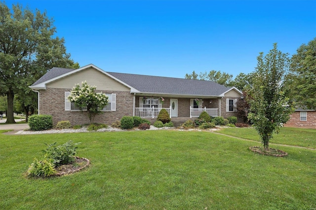 ranch-style house with a front yard, a porch, and brick siding