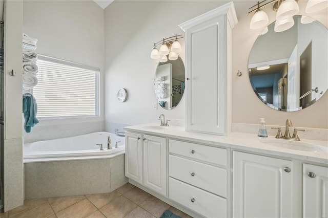 bathroom with double vanity, a sink, a bath, and tile patterned floors
