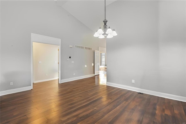 empty room with high vaulted ceiling, baseboards, dark wood-style flooring, and a notable chandelier