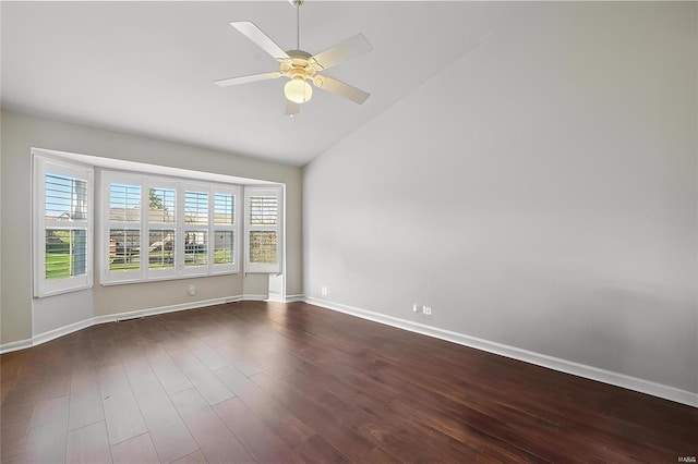 unfurnished room with dark wood-style flooring, a ceiling fan, baseboards, and high vaulted ceiling