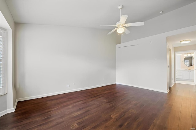 unfurnished room with vaulted ceiling, baseboards, a ceiling fan, and wood finished floors