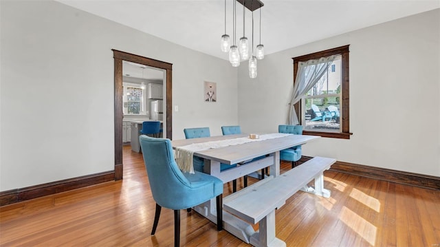 dining space featuring hardwood / wood-style floors and baseboards