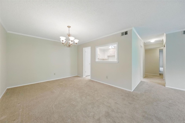 unfurnished room with a chandelier, visible vents, crown molding, and light carpet