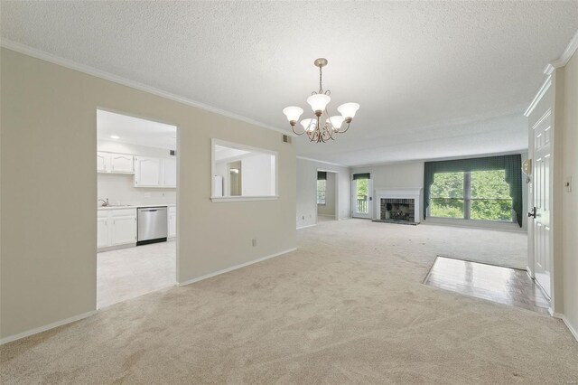 unfurnished living room with a chandelier, a textured ceiling, ornamental molding, and light carpet