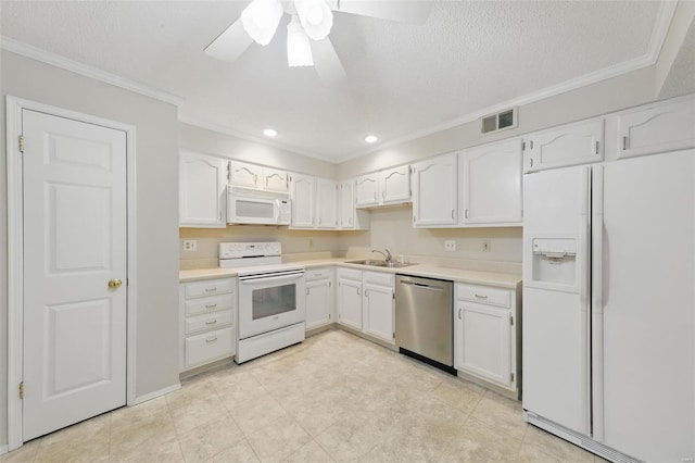kitchen featuring white cabinets, a sink, visible vents, white appliances, and crown molding