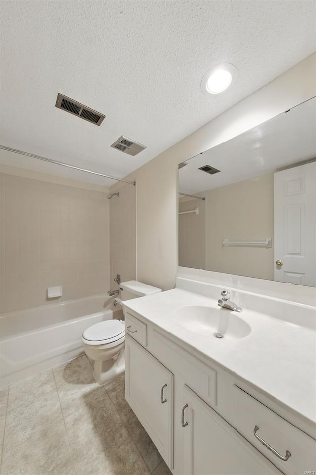 bathroom featuring a textured ceiling, visible vents, and toilet