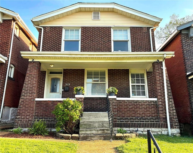 view of front of property with a porch and brick siding