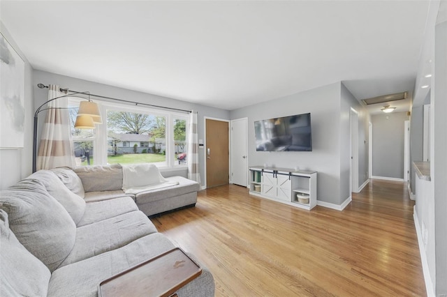 living room featuring baseboards and light wood-style floors