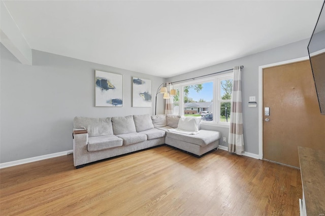 living area with wood finished floors and baseboards