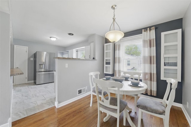 dining area featuring baseboards and visible vents