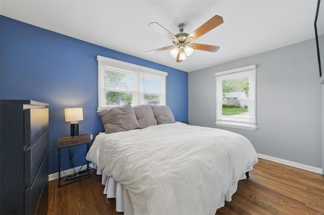 bedroom with baseboards, wood finished floors, and ceiling fan