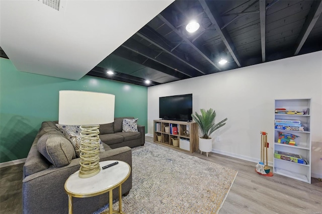 living room with visible vents, wood finished floors, and baseboards