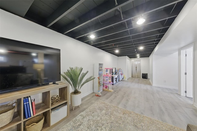 interior space with baseboards and wood finished floors